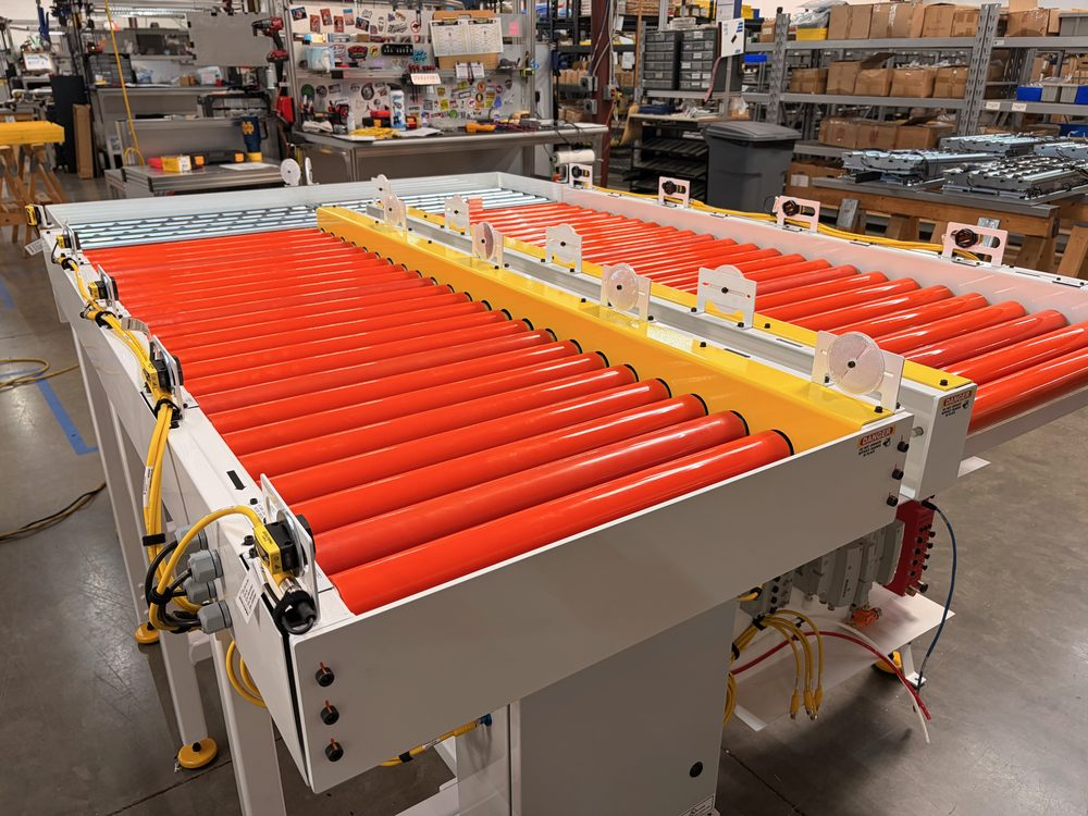 Direct Conveyors MDR roller conveyor with orange Rolmaster rollers and yellow safety edges, overhead view showing accumulation zones