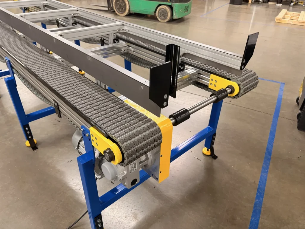 Dual lane modular plastic belt conveyor with adjustable side guides and tubular steel frame, three-quarter view